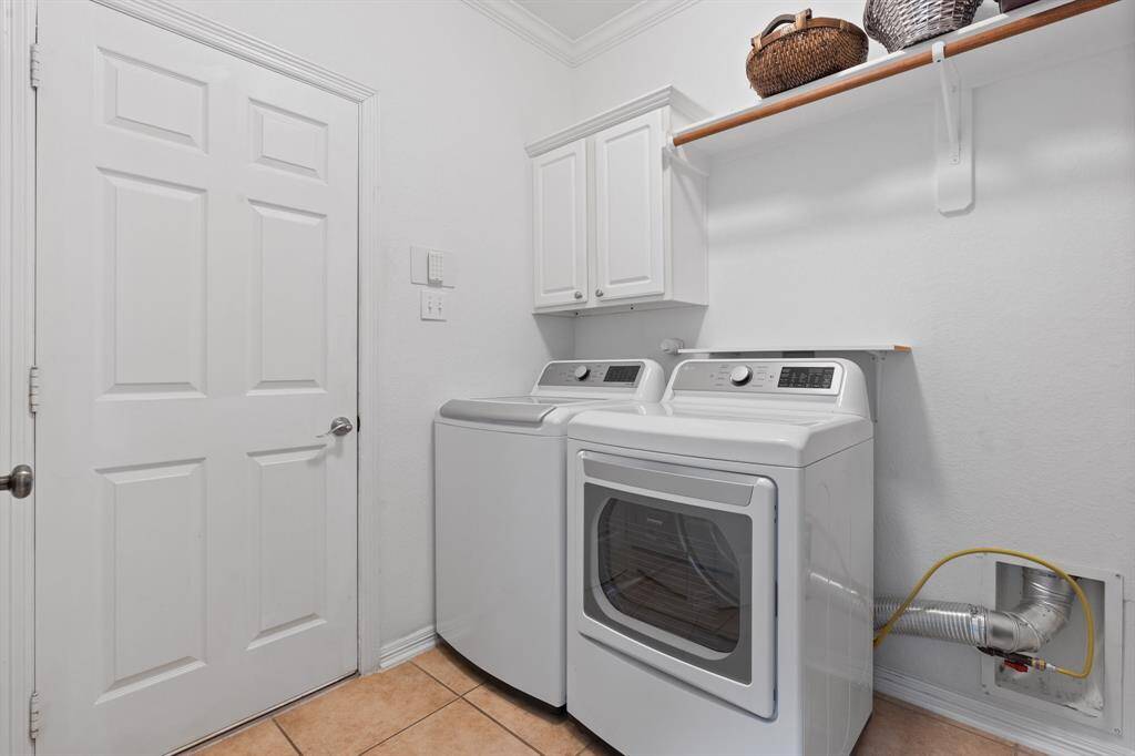 This is a clean and functional laundry room with a shelf for organization.