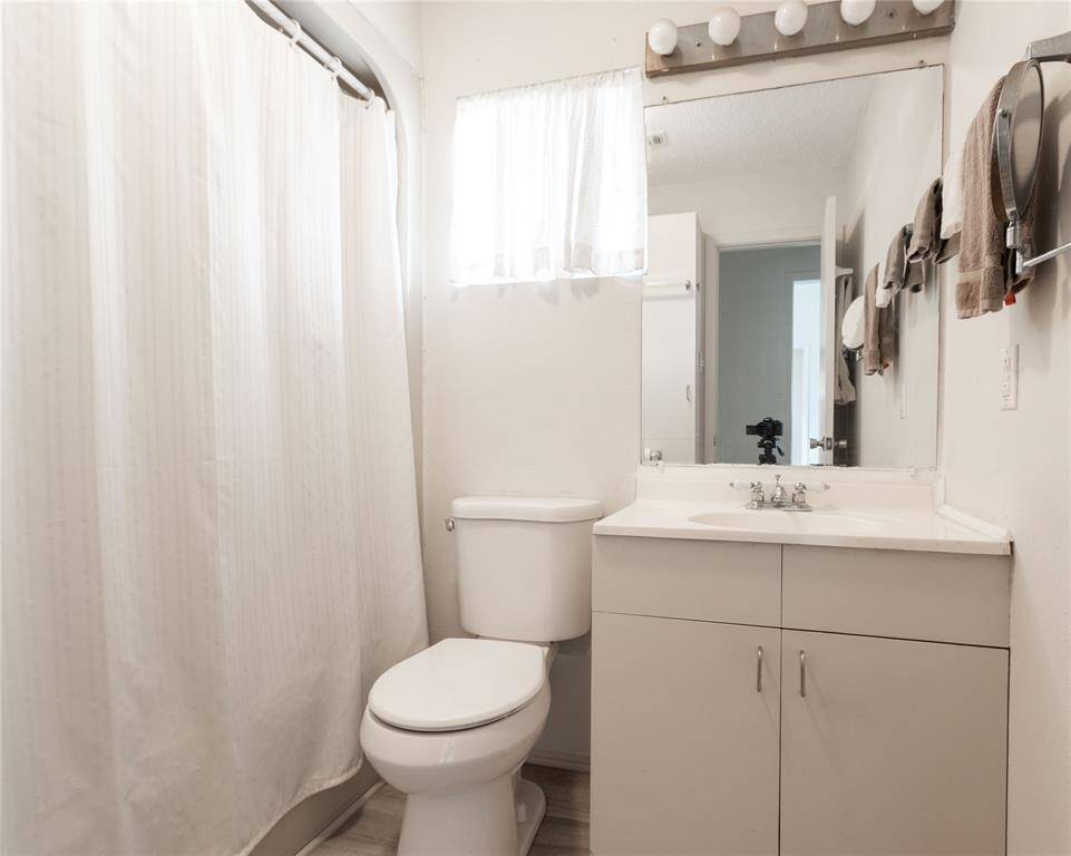 Bright and inviting primary bathroom with modern fixtures and ample storage.