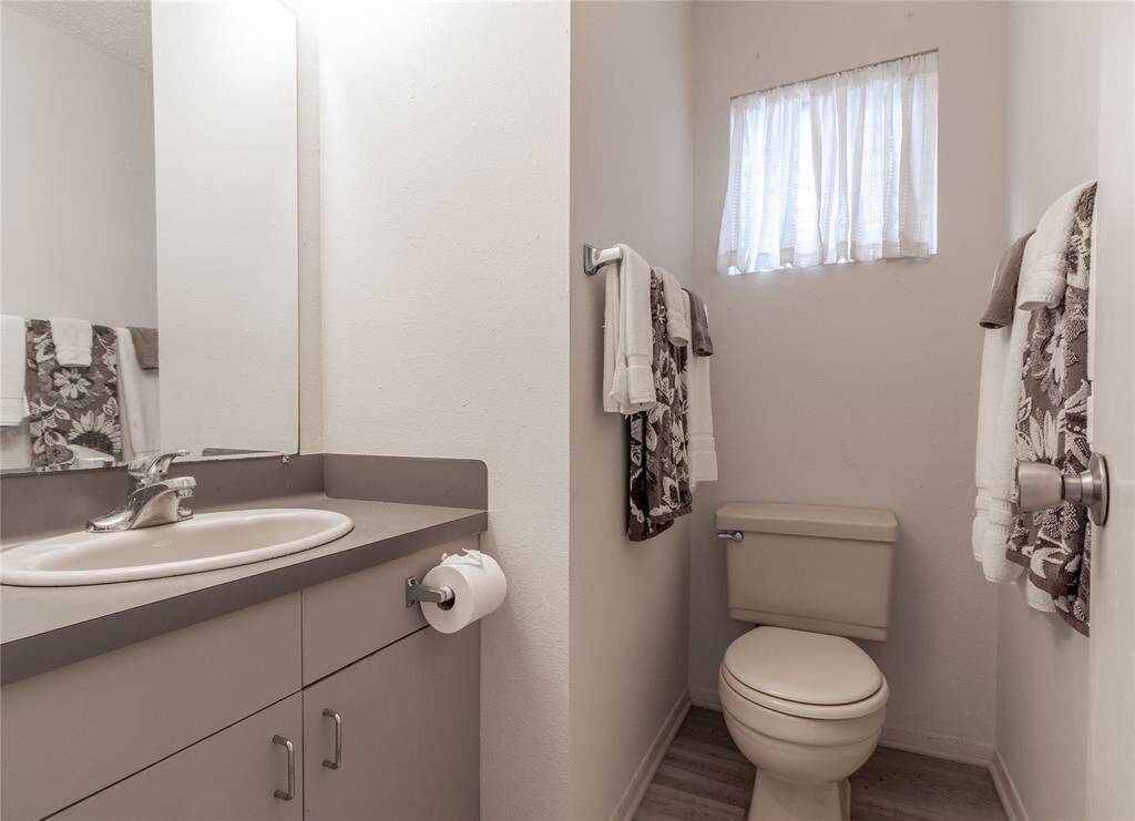 Charming guest bathroom with modern fixtures and ample storage.