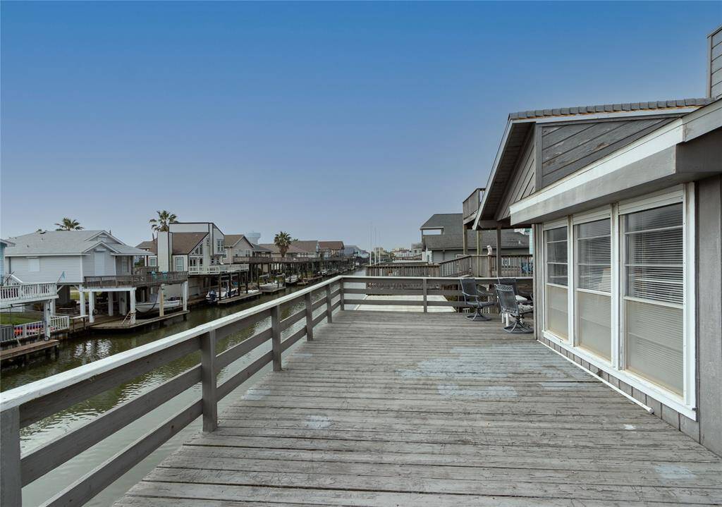 Spacious waterfront deck with expansive canal views, perfect for relaxing or entertaining. The home features large windows for natural light and scenic enjoyment. Ideal for those seeking a serene, waterside lifestyle.