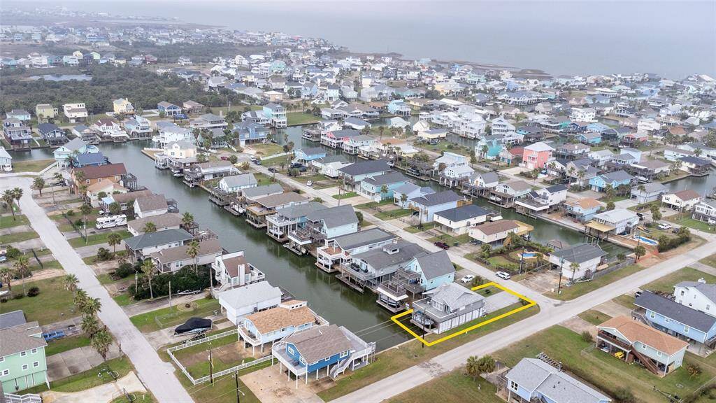 This photo showcases a coastal neighborhood with homes along a canal. The highlighted property is a waterfront house, offering direct access to the water.