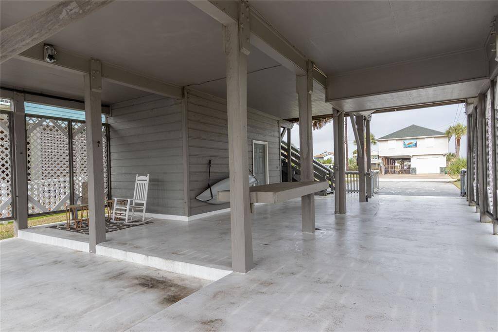 This photo shows a waterfront/canal property with a private boat lift and dock, ideal for boating enthusiasts. The area features a covered structure and is situated along a peaceful canal, providing easy water access and scenic views of neighboring homes.  Boat not included.