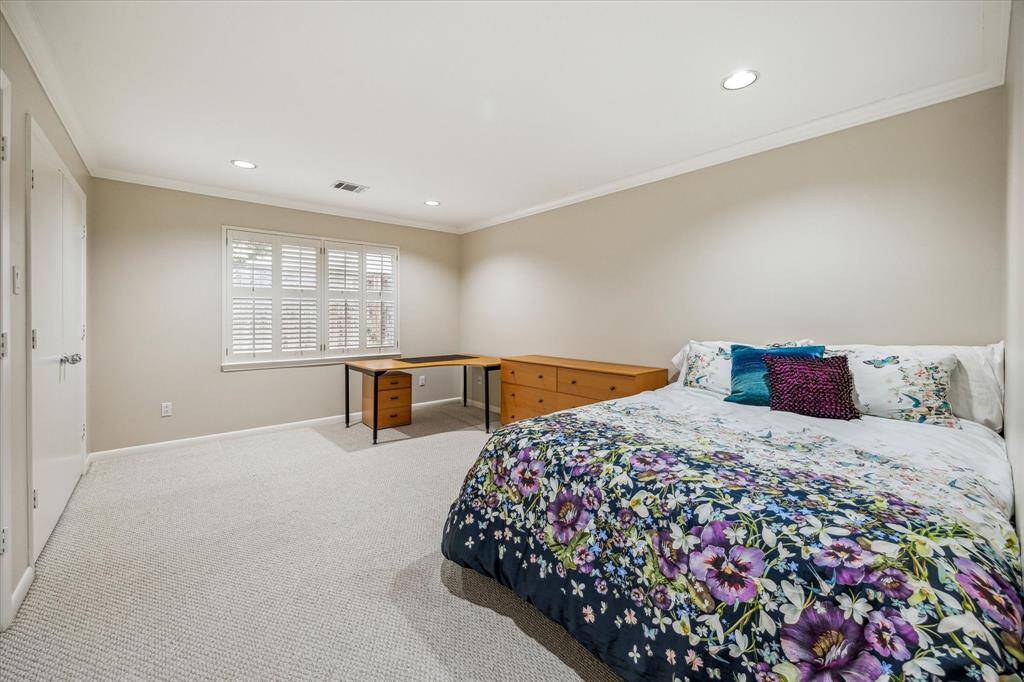 One of three secondary bedrooms, the generous room sizes offer space for furnishings and plenty of room to move. Two closets offer ample storage space for clothes and accessories.