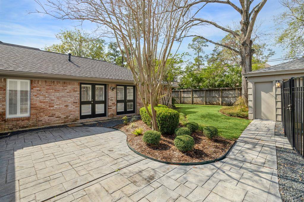 The backyard and large patio is a private oasis perfect for outdoor dining or enjoying a morning coffee.