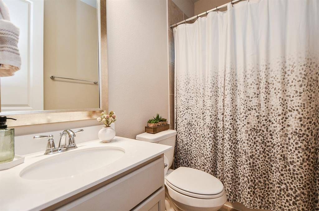 This is the 4th full bathroom located in between the 4th bedroom and gameroom