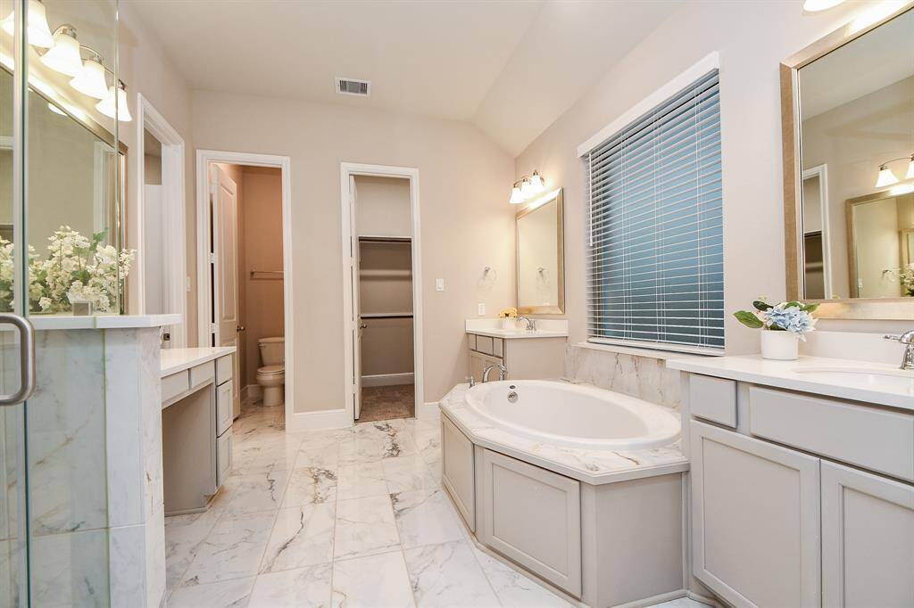 This amazing primary bathroom has 3 vanities!