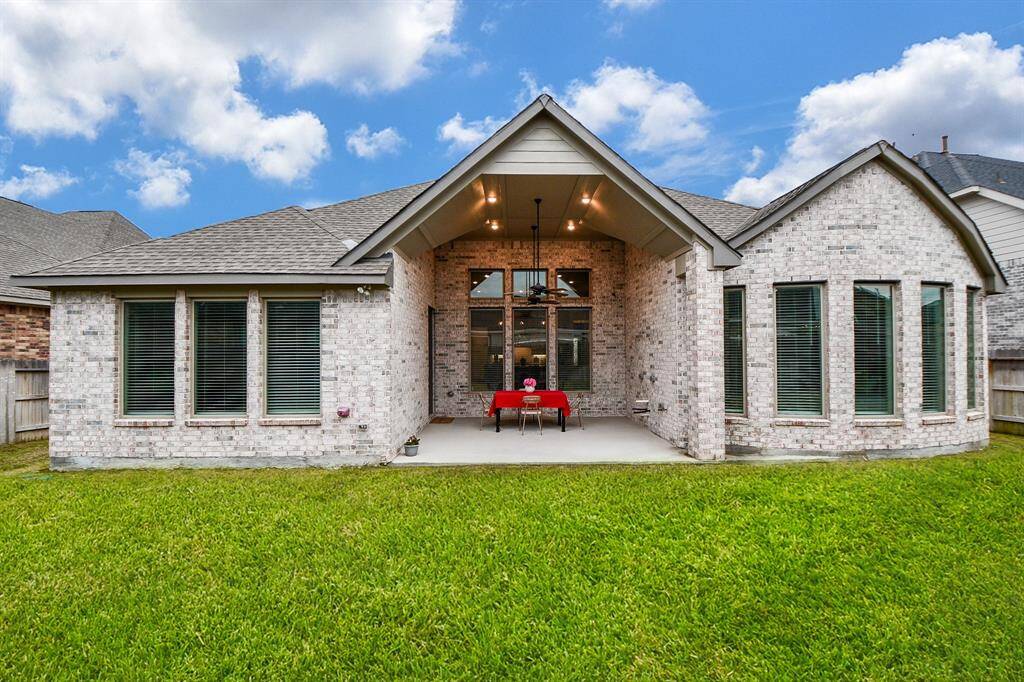 Rear exterior of the home  with a huge covered patio, perfect for outdoor dining and entertaining.