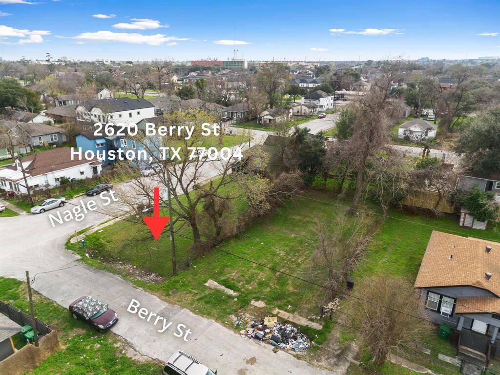 This lower-altitude aerial view offers a closer look at the lot’s terrain, street frontage, and immediate surroundings. The detailed angle highlights the property’s accessibility and buildable space, giving a clear sense of scale for future development.