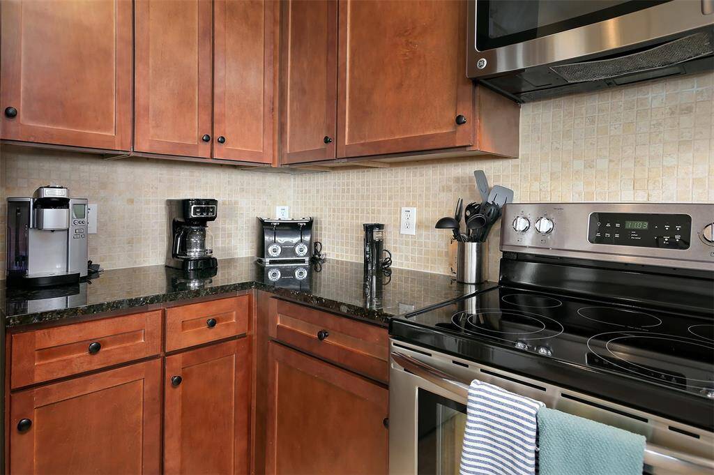 Start your mornings right with a dedicated coffee station, generous counter space, and all the essentials for effortless meal prep in this well-appointed kitchen.