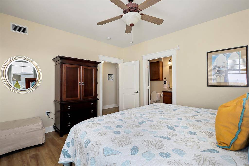 This well-appointed primary suite offers a generous layout, a ceiling fan for comfort, and an en-suite bath for added convenience.