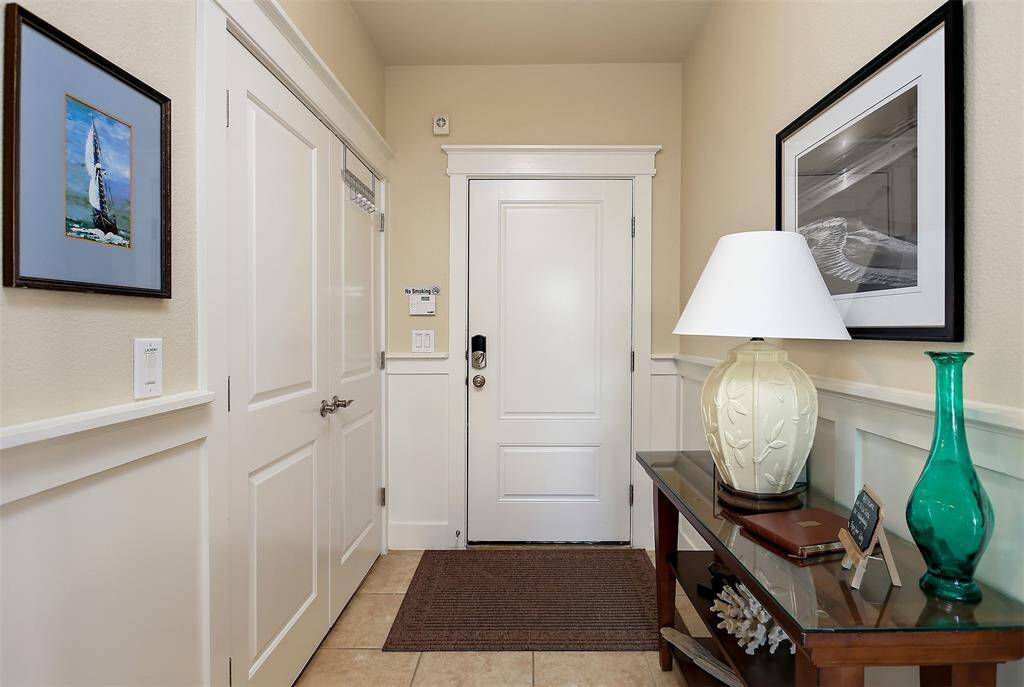 Step into a bright and inviting foyer with elegant wainscoting, tile flooring, and thoughtfully curated coastal décor to set the perfect first impression.