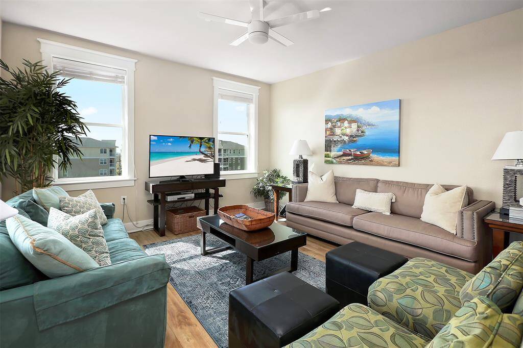 This inviting living space boasts neutral tones, abundant natural light, and a serene coastal aesthetic, creating the perfect setting for unwinding after a day at the beach.
