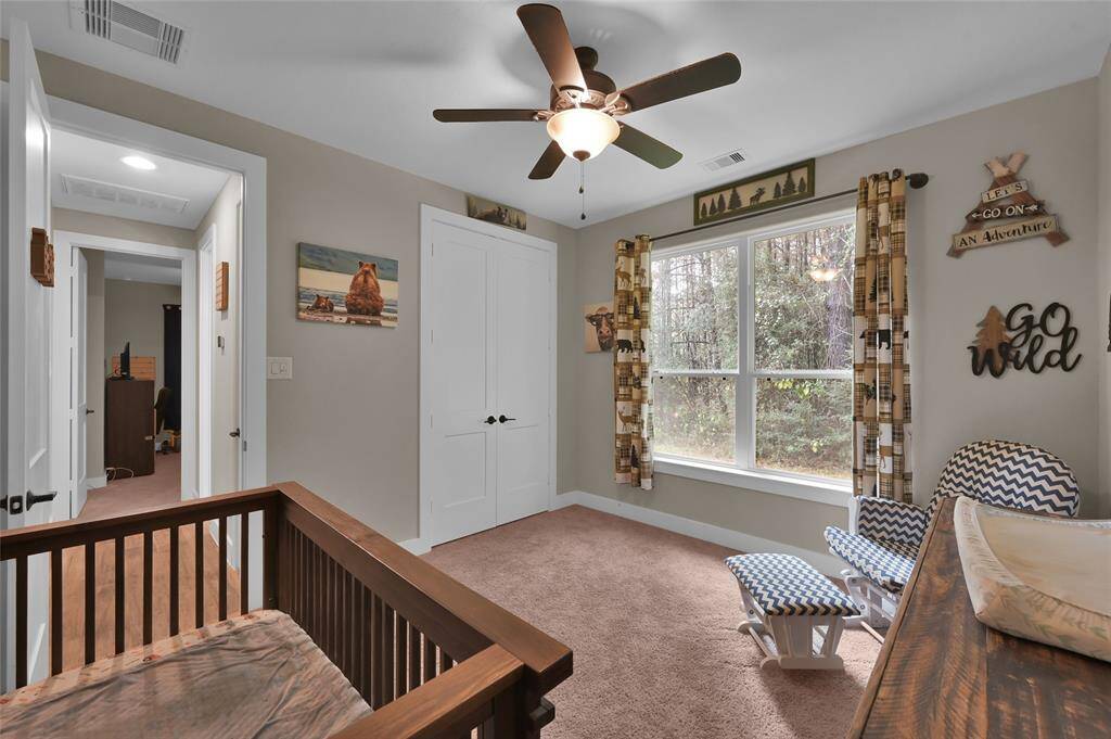 Bright and inviting secondary bedroom with a large window.