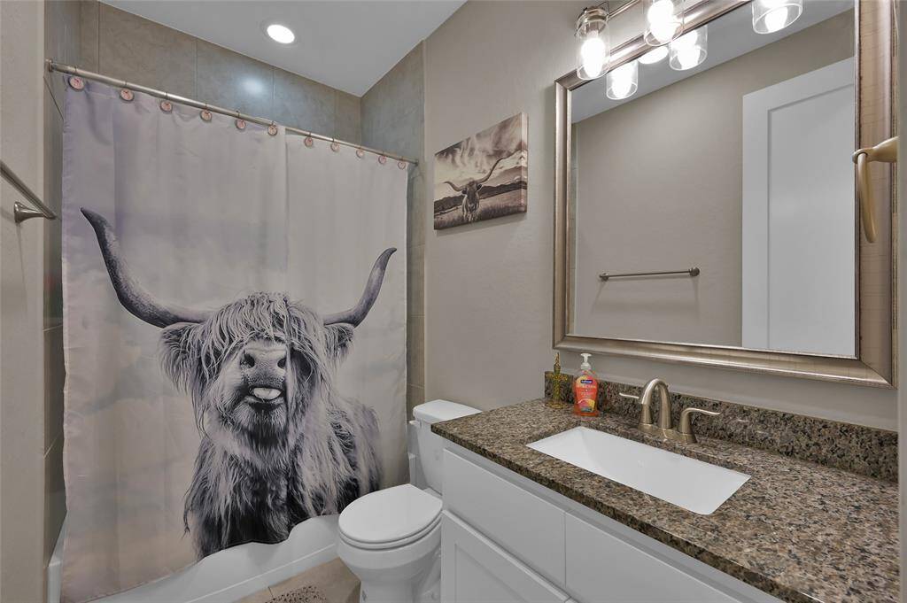 Conveniently located near the entrance, the secondary bathroom offers easy access and modern design.