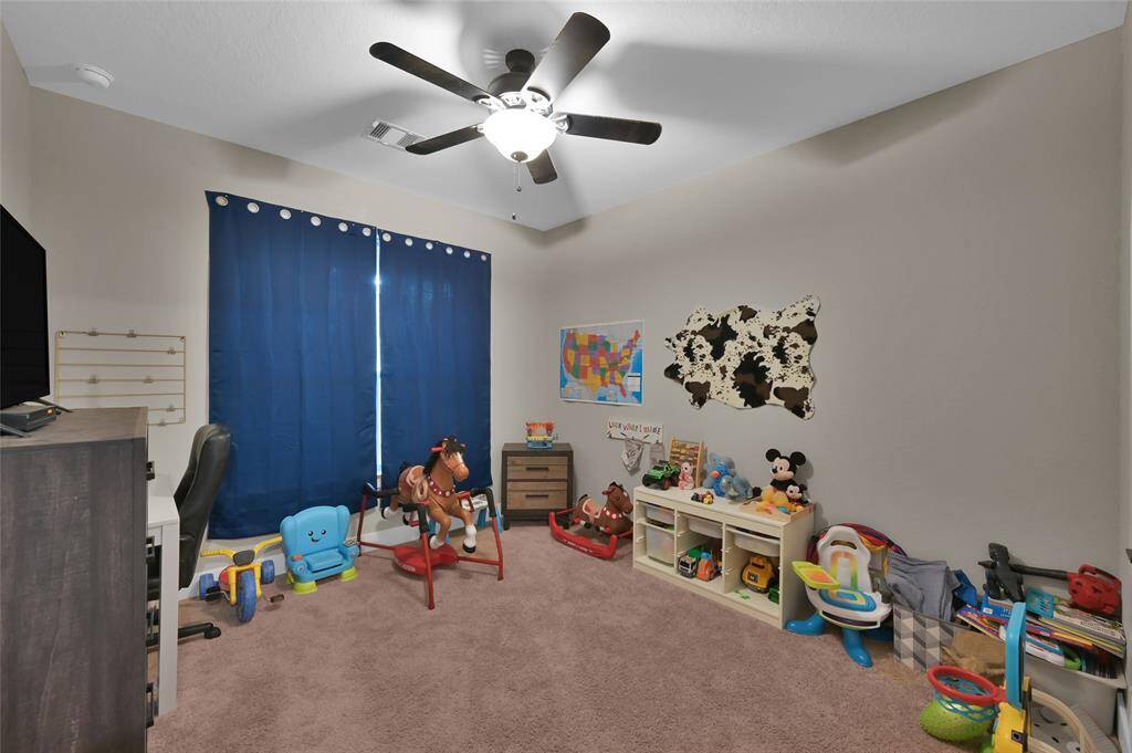 Step into the charming second bedroom, perfect for a child’s playroom or cozy guest space.