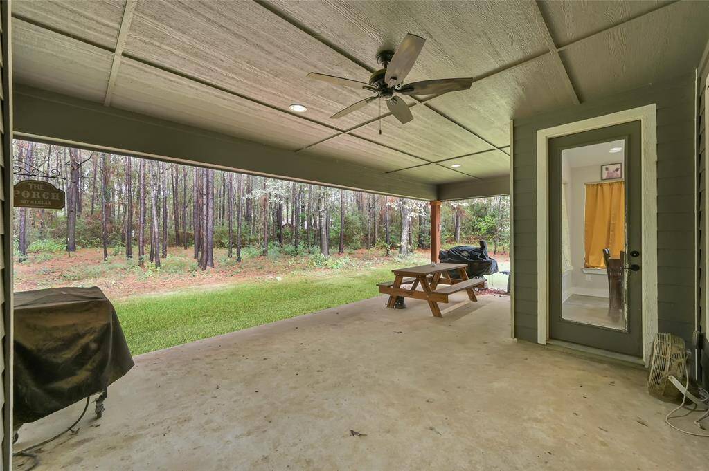 Enjoy serene moments on your shaded, covered back porch overlooking a tranquil backyard.