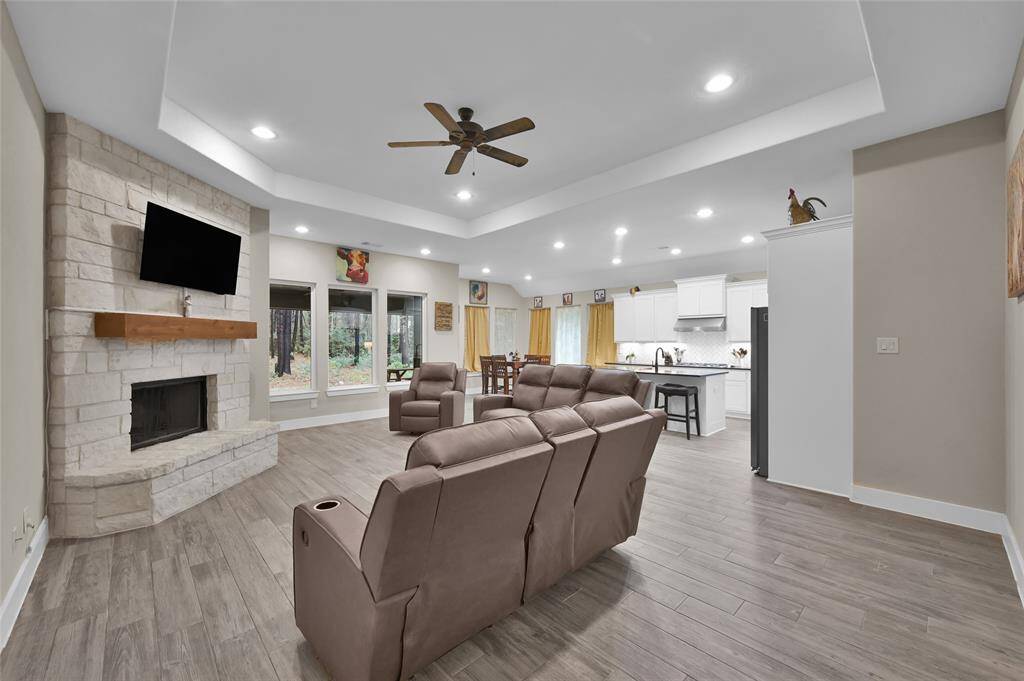 Cozy up by the stone fireplace and enjoy stunning backyard views.