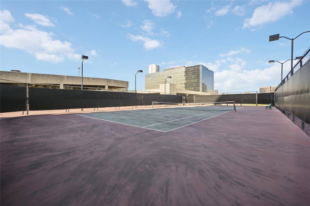 Lighted tennis and pickleball courts on roof of parking garage