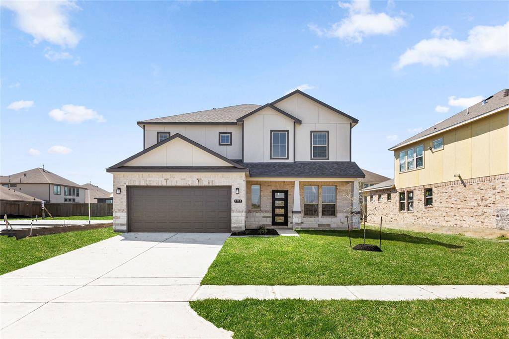 This modern two-story home features a spacious front yard, a double garage, and a sleek exterior design with neutral tones. Located in a suburban neighborhood, it offers a welcoming atmosphere and ample living space.