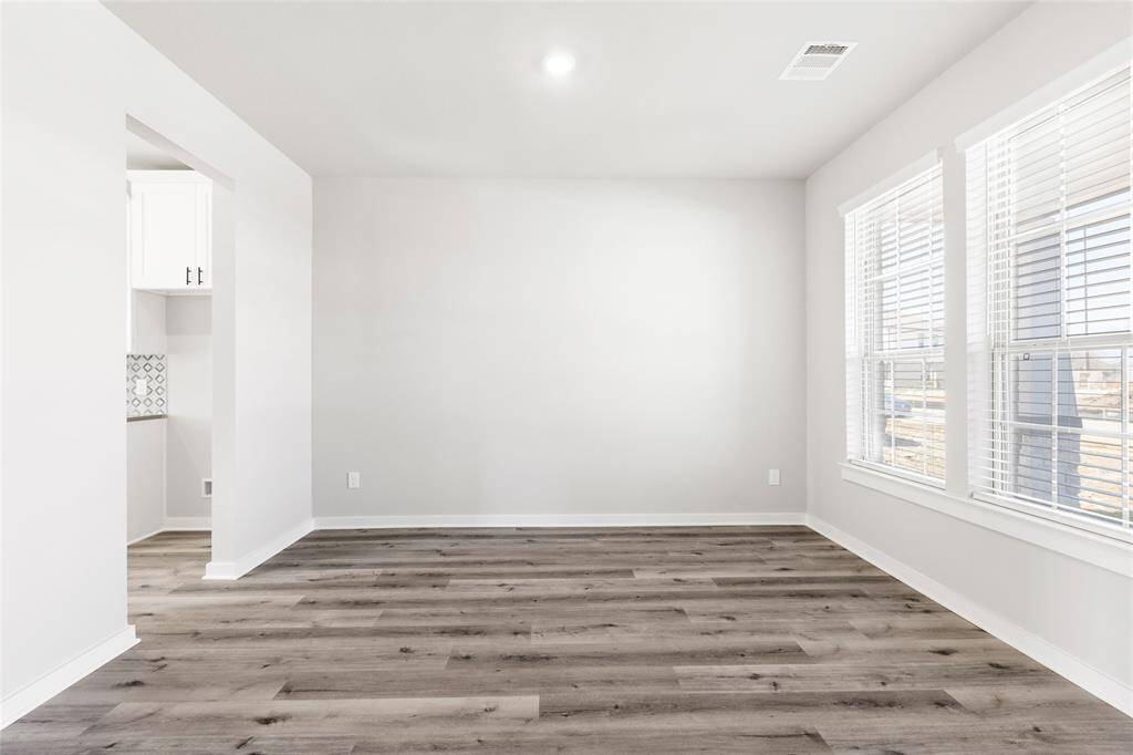 This modern two-story home features a spacious front yard, a double garage, and a sleek exterior design with neutral tones. Located in a suburban neighborhood, it offers a welcoming atmosphere and ample living space.