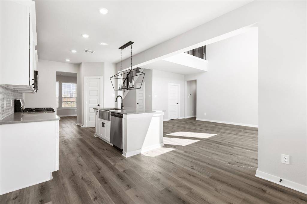 This modern two-story home features a spacious front yard, a double garage, and a sleek exterior design with neutral tones. Located in a suburban neighborhood, it offers a welcoming atmosphere and ample living space.