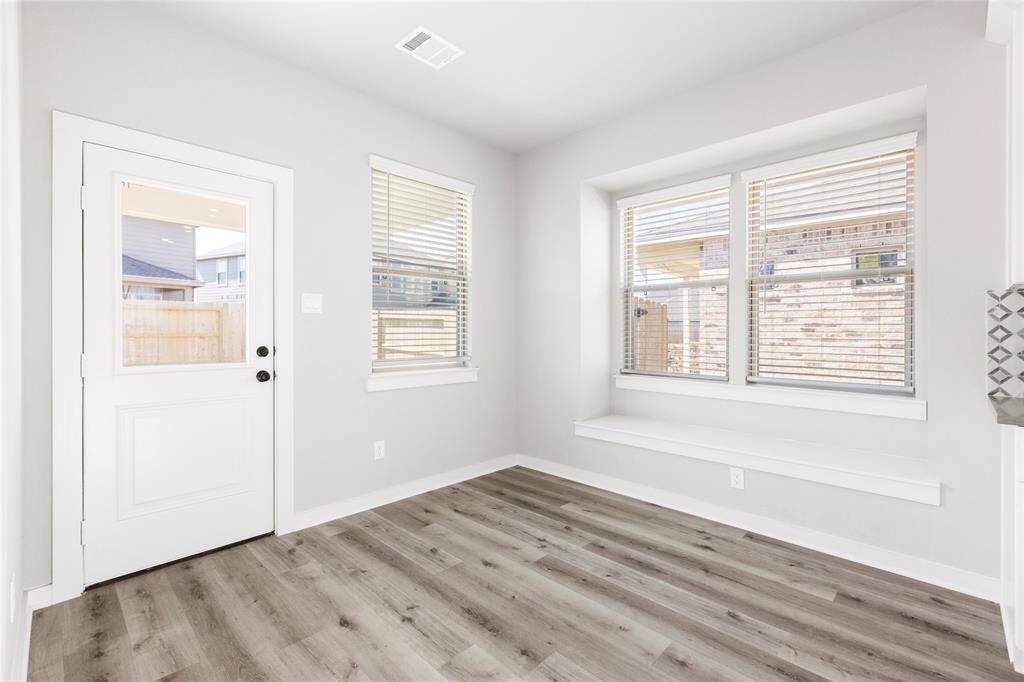 This modern two-story home features a spacious front yard, a double garage, and a sleek exterior design with neutral tones. Located in a suburban neighborhood, it offers a welcoming atmosphere and ample living space.