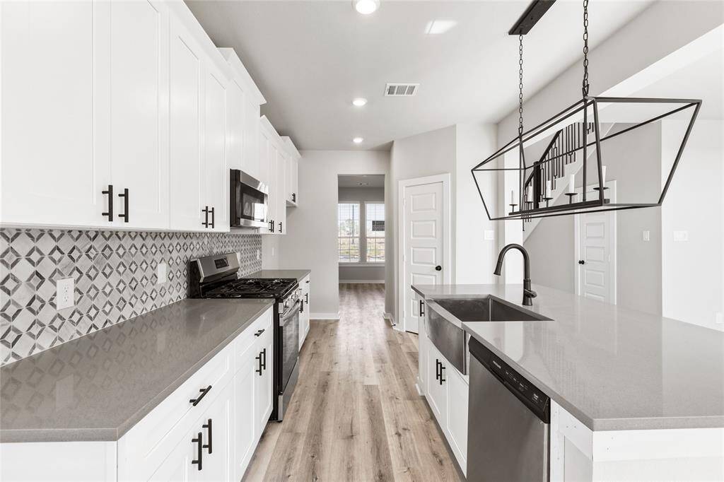 This modern two-story home features a spacious front yard, a double garage, and a sleek exterior design with neutral tones. Located in a suburban neighborhood, it offers a welcoming atmosphere and ample living space.