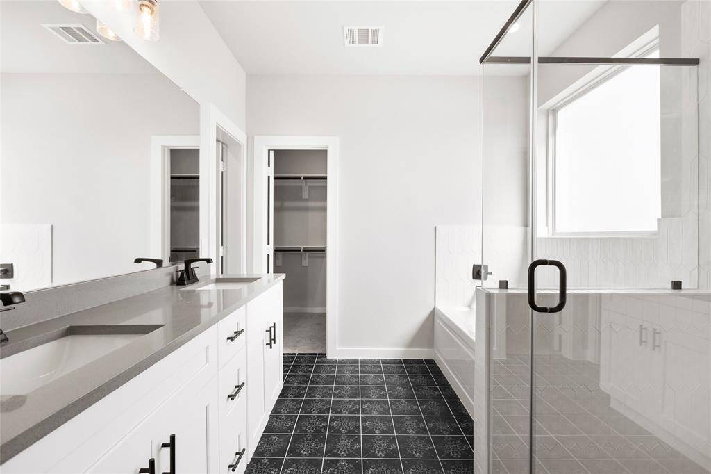 This modern two-story home features a spacious front yard, a double garage, and a sleek exterior design with neutral tones. Located in a suburban neighborhood, it offers a welcoming atmosphere and ample living space.