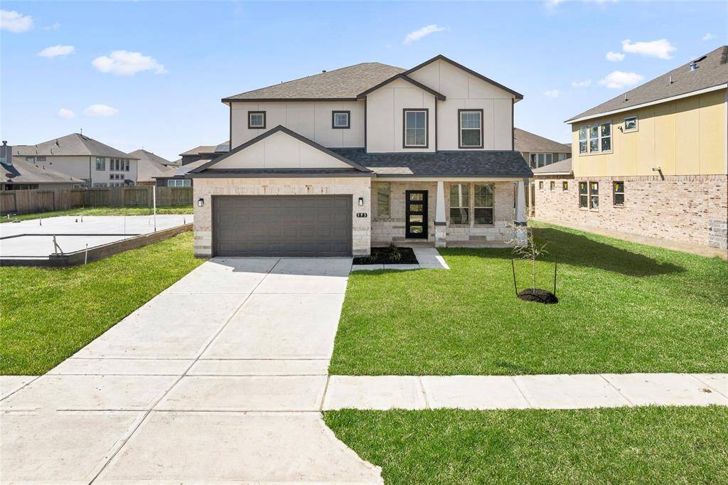 This modern two-story home features a spacious front yard, a double garage, and a sleek exterior design with neutral tones. Located in a suburban neighborhood, it offers a welcoming atmosphere and ample living space.