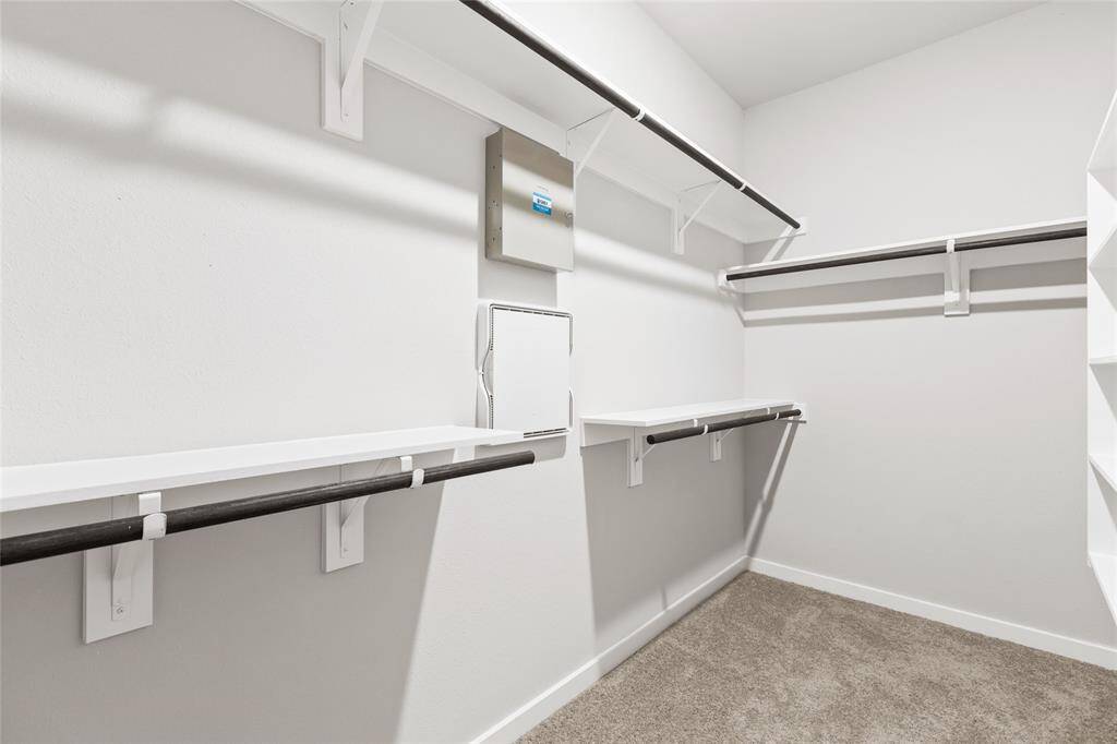 This modern two-story home features a spacious front yard, a double garage, and a sleek exterior design with neutral tones. Located in a suburban neighborhood, it offers a welcoming atmosphere and ample living space.
