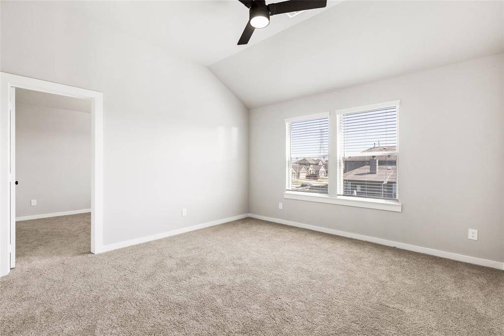 This modern two-story home features a spacious front yard, a double garage, and a sleek exterior design with neutral tones. Located in a suburban neighborhood, it offers a welcoming atmosphere and ample living space.