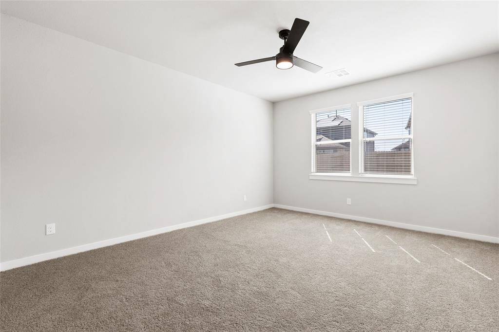 This modern two-story home features a spacious front yard, a double garage, and a sleek exterior design with neutral tones. Located in a suburban neighborhood, it offers a welcoming atmosphere and ample living space.