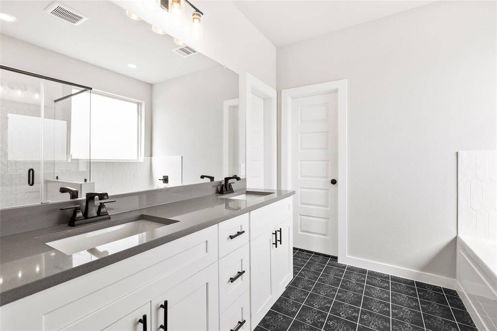This modern two-story home features a spacious front yard, a double garage, and a sleek exterior design with neutral tones. Located in a suburban neighborhood, it offers a welcoming atmosphere and ample living space.