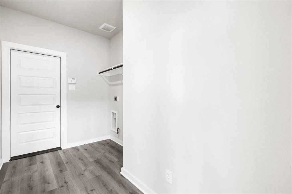 This modern two-story home features a spacious front yard, a double garage, and a sleek exterior design with neutral tones. Located in a suburban neighborhood, it offers a welcoming atmosphere and ample living space.