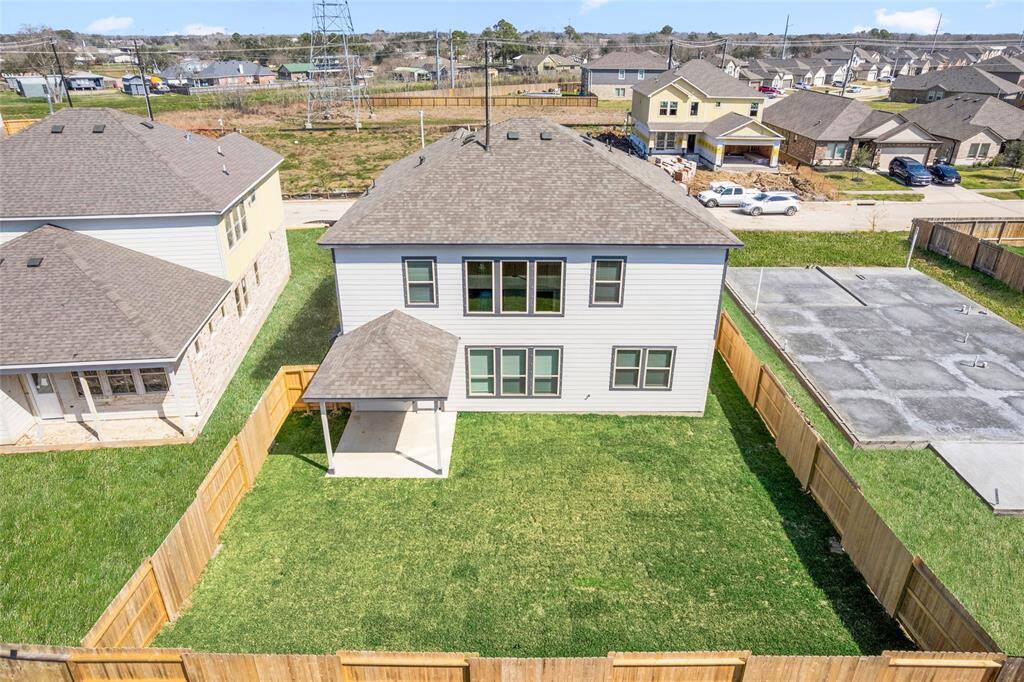 This modern two-story home features a spacious front yard, a double garage, and a sleek exterior design with neutral tones. Located in a suburban neighborhood, it offers a welcoming atmosphere and ample living space.