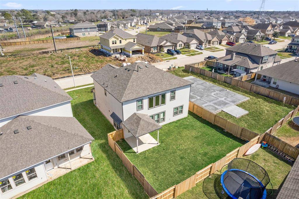 This modern two-story home features a spacious front yard, a double garage, and a sleek exterior design with neutral tones. Located in a suburban neighborhood, it offers a welcoming atmosphere and ample living space.
