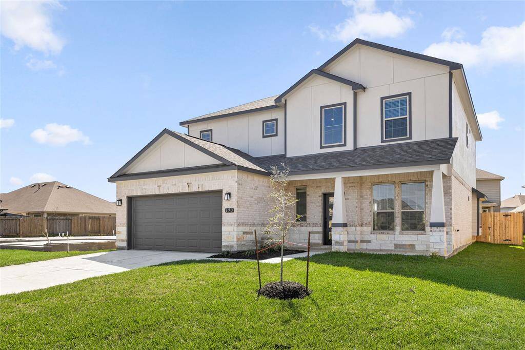 This modern two-story home features a spacious front yard, a double garage, and a sleek exterior design with neutral tones. Located in a suburban neighborhood, it offers a welcoming atmosphere and ample living space.