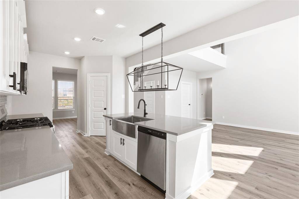 This modern two-story home features a spacious front yard, a double garage, and a sleek exterior design with neutral tones. Located in a suburban neighborhood, it offers a welcoming atmosphere and ample living space.
