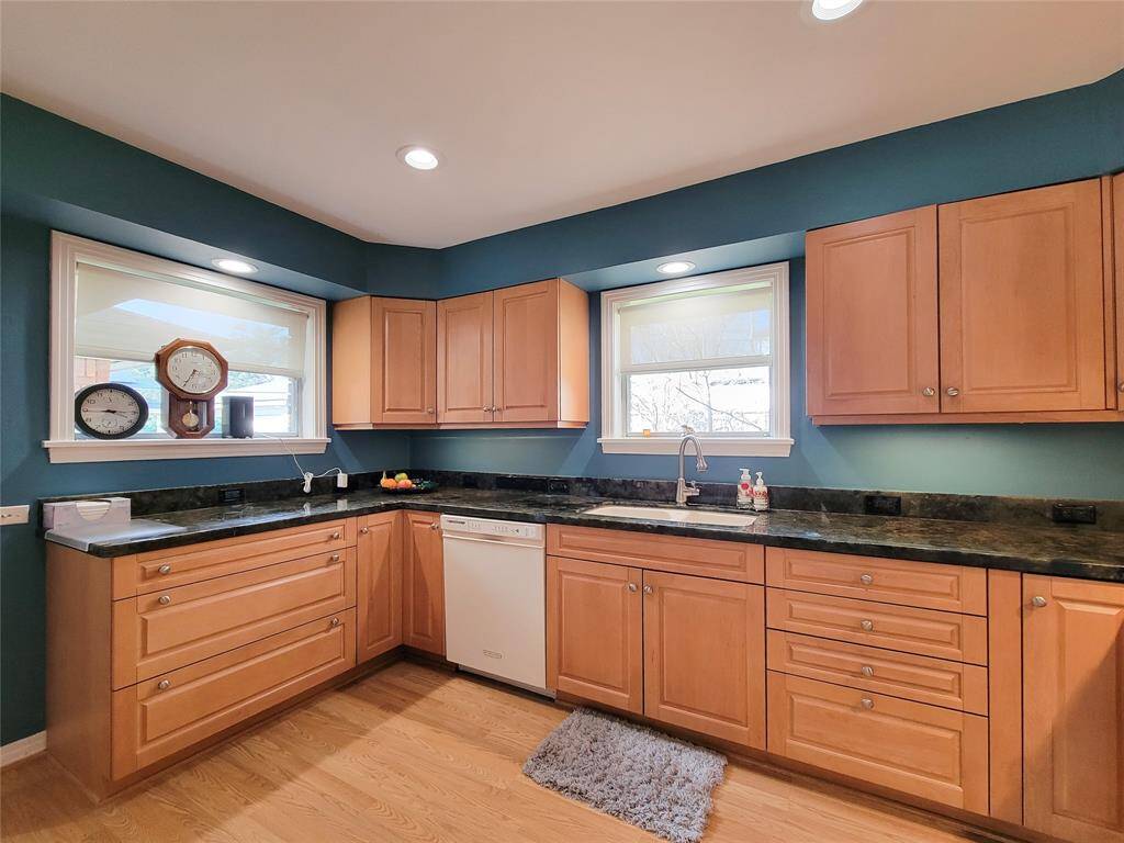 This inviting kitchen features warm wood cabinetry with lots of storage and counter space. Large double sink, gas cooking, and the refrigerator remains.