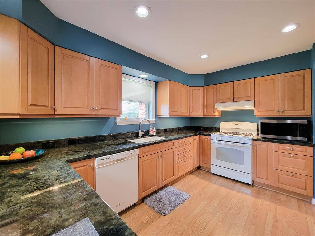 Updated kitchen with wood cabinetry, lots of counter space, recessed lights and gas cooking!