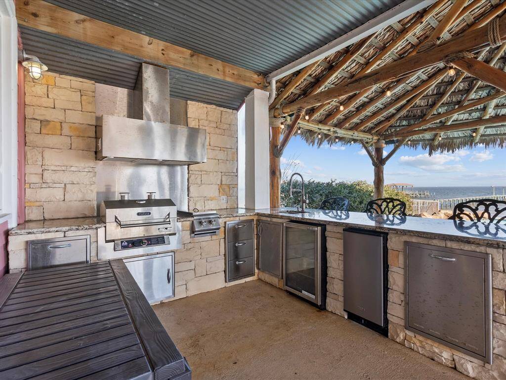 Outdoor kitchen with gas grill, refrigerator, sink