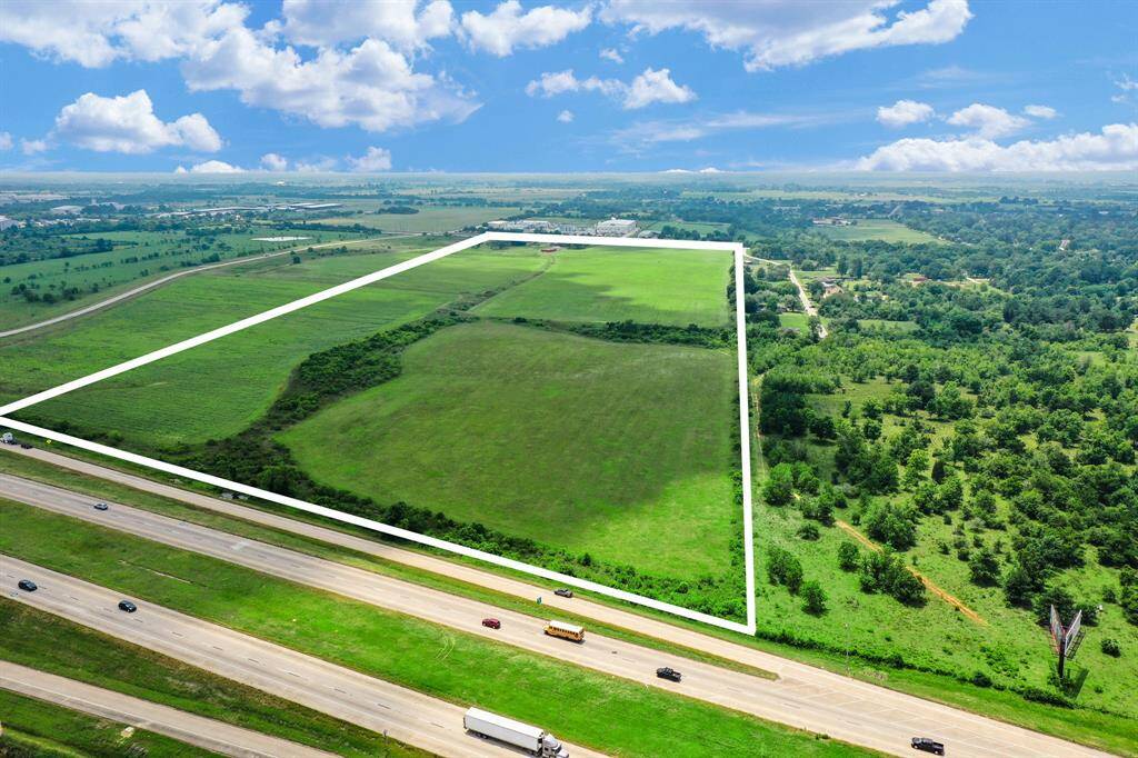 101+ unrestricted acres directly on Hwy 290 West. This view facing south from Hwy 290. James Muse Parkway is shown to the far left.