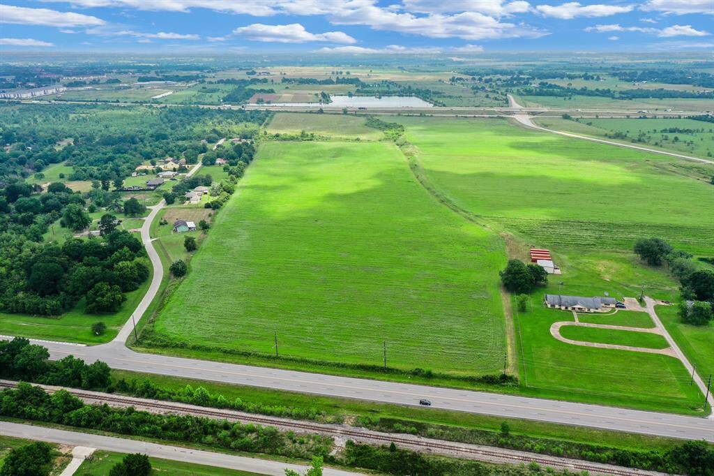 North-facing view with old Business Hwy 290 at bottom and Hwy 290 near the topo.