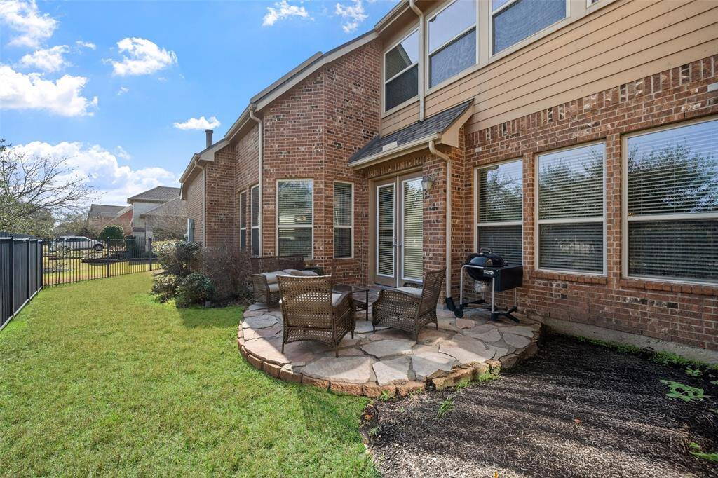 The side patio area offers a pleasant outdoor space for relaxation or entertaining.