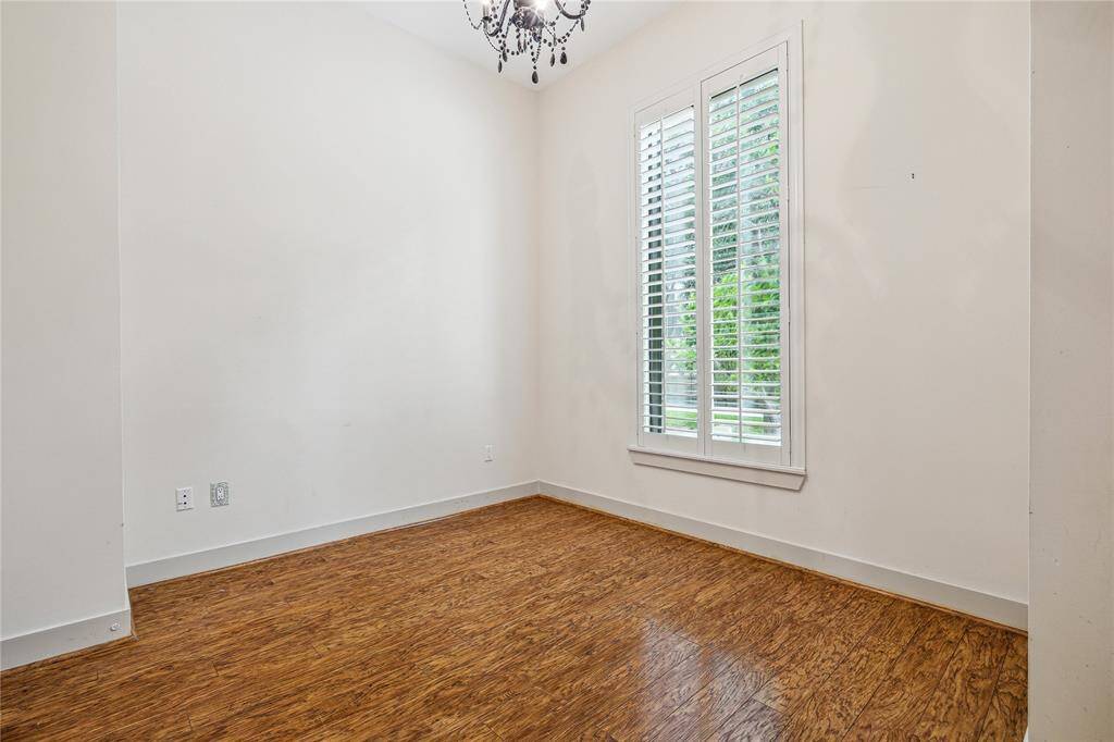 The Third Secondary Bedroom with lustrous hardwood floors, plantation shutters and high ceilings.