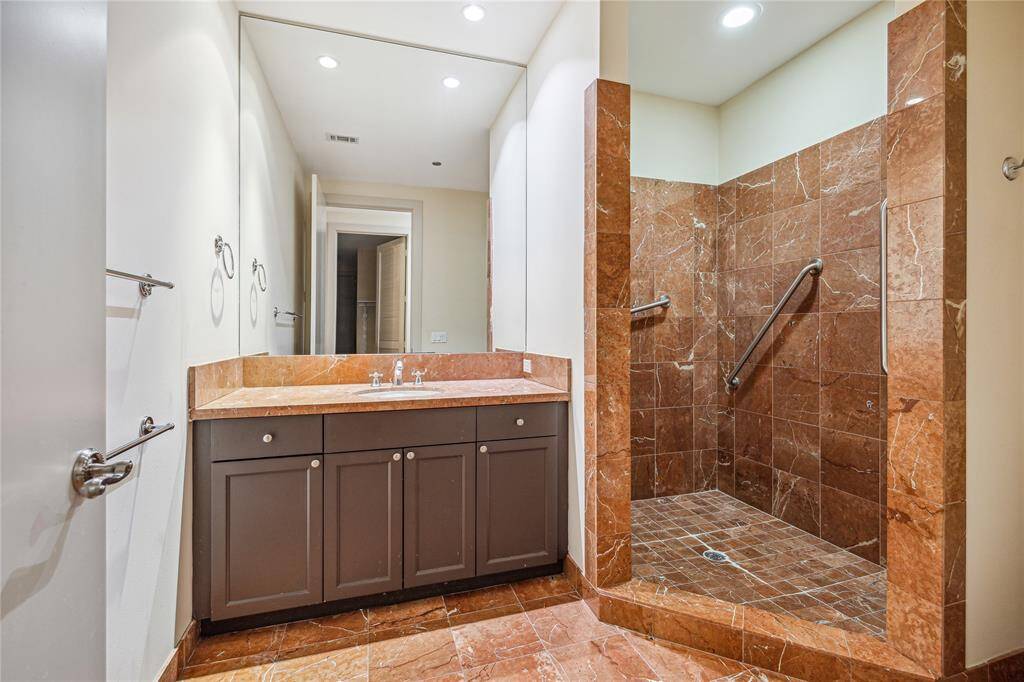 The second Full Bath with large step-in shower and fine stone finishes.