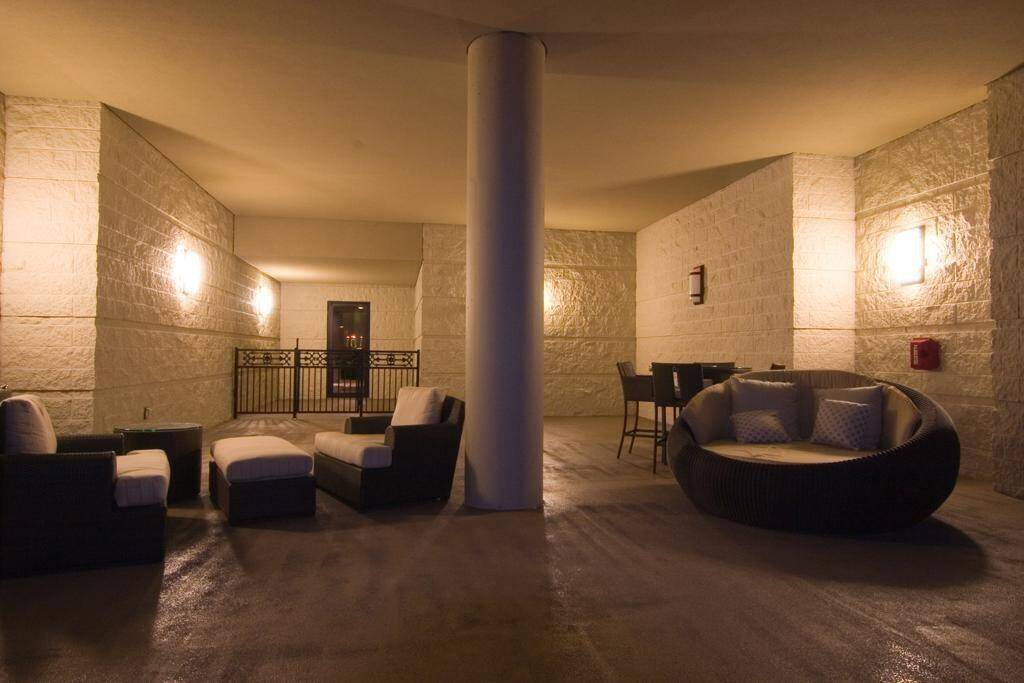 The area is covered and adjacent to the pool for outside relaxation.