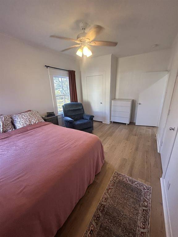 Primary bedroom with closet in the background to the left. Private entrance to bath is the first door on the right with the next doorway accessing kitchen.