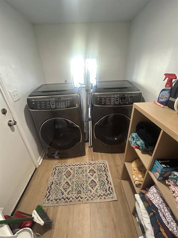 Utility room with backdoor to backyard to the left. Washer and dryer do stay with the property.