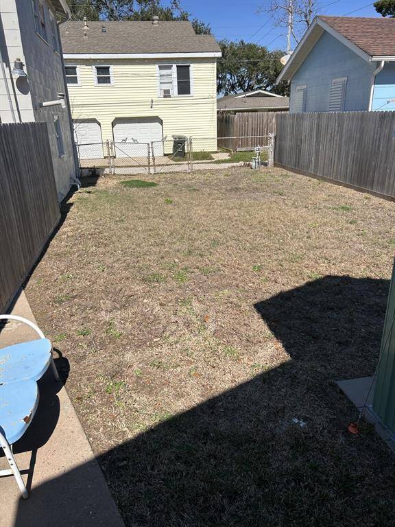 Fenced backyard with double gates accessing backyard.